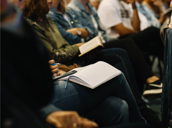 row of people taking notes for a facilitation company